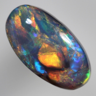 SOLID BLACK OPAL Cherry red and orange over a green/blue background